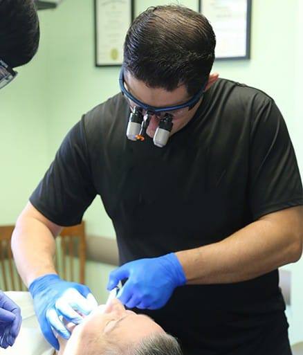 Dentist examining smile before tooth extraction