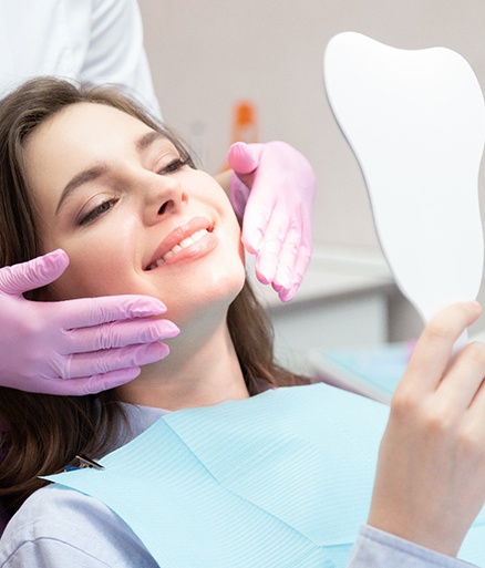 patient smiling while visiting cosmetic dentist 