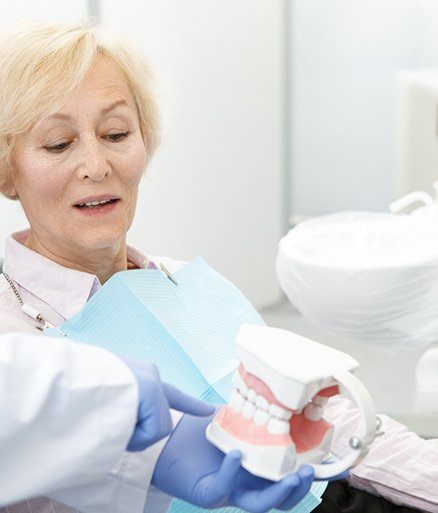 Dental patient discussing all on four dental implants with her dentist