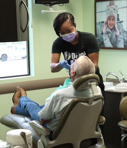 Dental team member providing dental bonding treatment