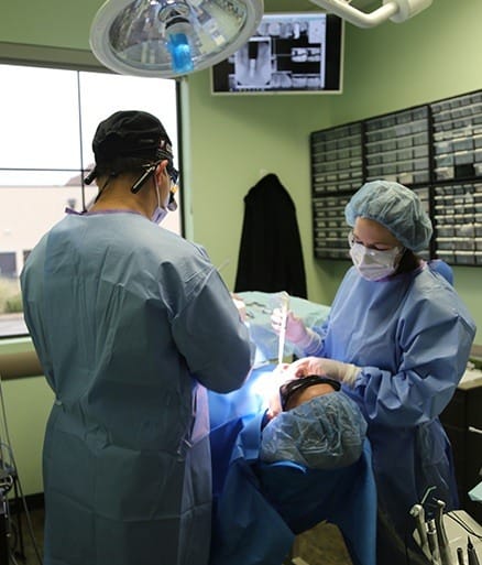 Dentists performing full mouth reconstruction