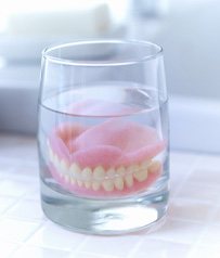 Dentures soaking in glass