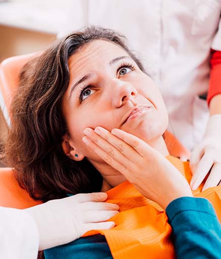 Woman with toothache visiting her Glenpool emergency dentist