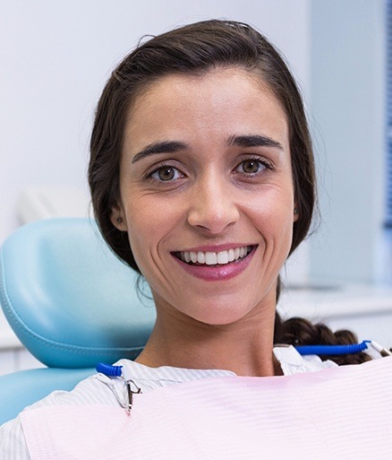 Woman smiling after tooth colored filling treatment