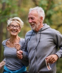 Older man and woman running outdoors