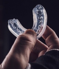 Hand holding a protective mouthguard