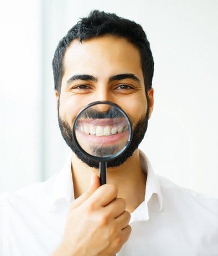 Man showing off smile as he enjoys the benefits of Invisalign
