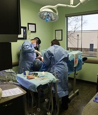 Dentist and team member treating patient under I V dental sedation