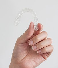 Patient holding up clear aligner