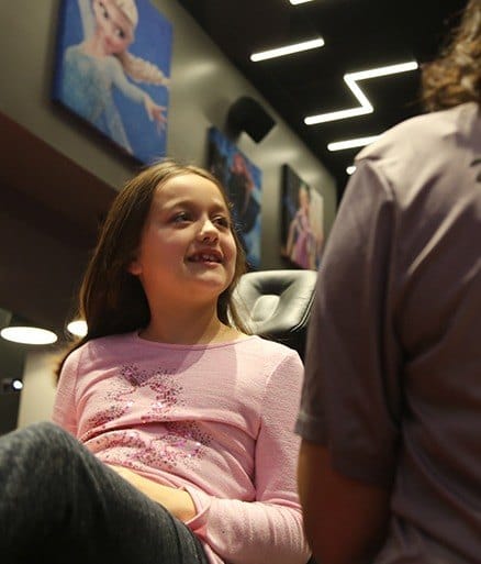 Child talking to dentist during orthodontic exam