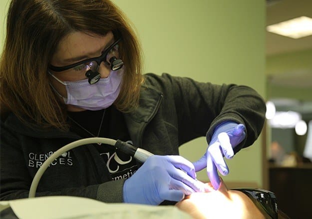 Dental team member providing periodontal therapy