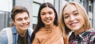 Three teens with healthy smiles after restorative dentistry