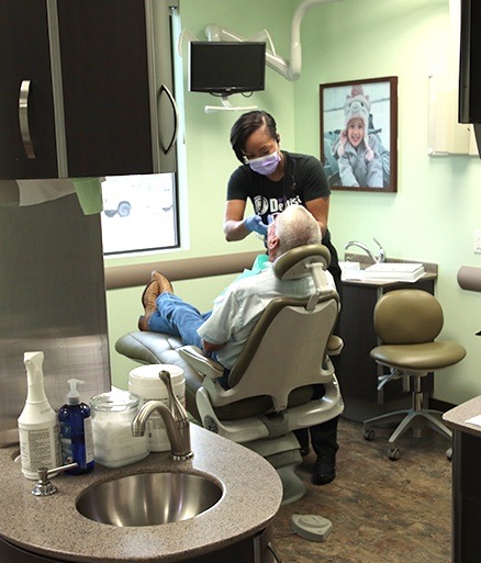 Dental team member using E 4 D one visit digital impression and dental restoration system