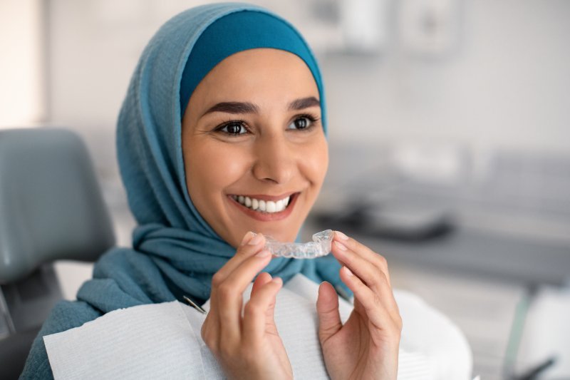 Patient smiling with their Invisalign aligner